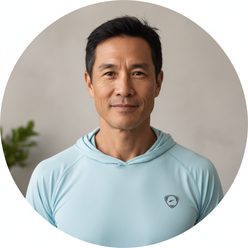 Circular portrait of adventurer Jimmy Chin, smiling confidently, wearing outdoor apparel against a clean, light background.